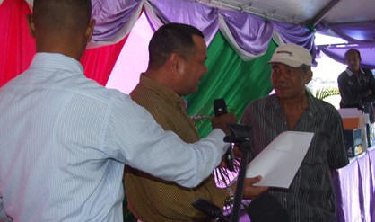 Minister Steven Relyveld van ROGB overhandigt Wagiran Martodikromo zijn stuk.
